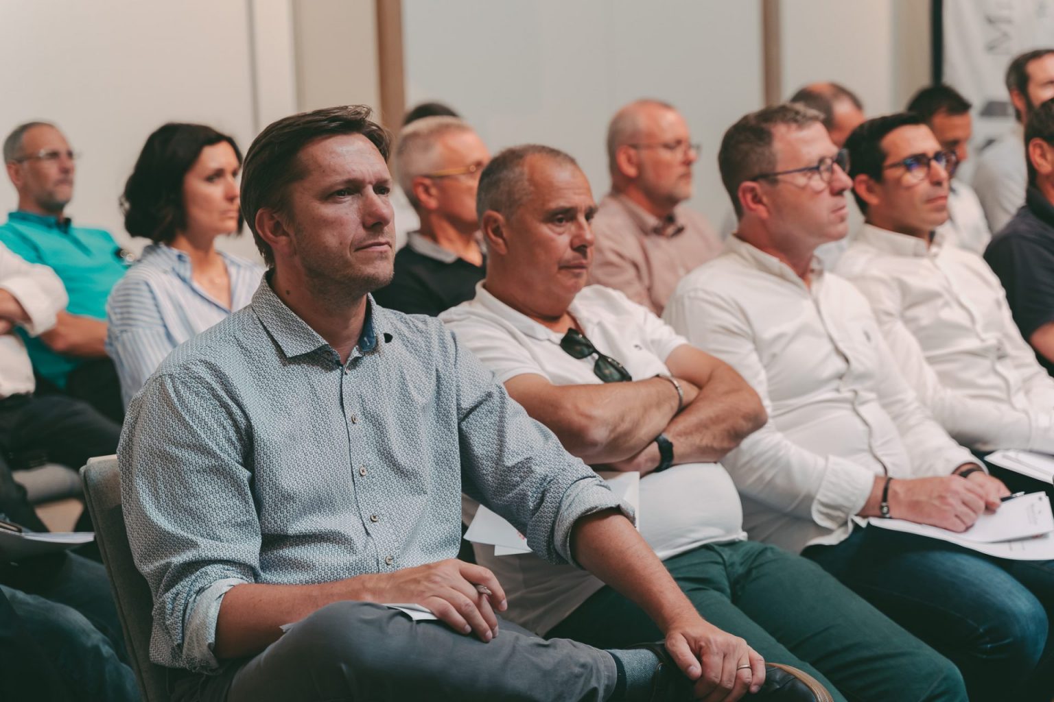 Photographie d'entreprise sur laquelle on voit une assemblée de personne qui assiste à une réunion